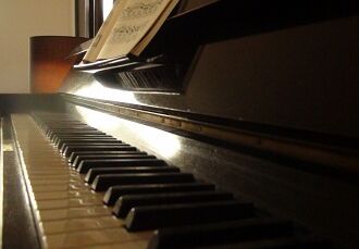 antique piano with ivory console